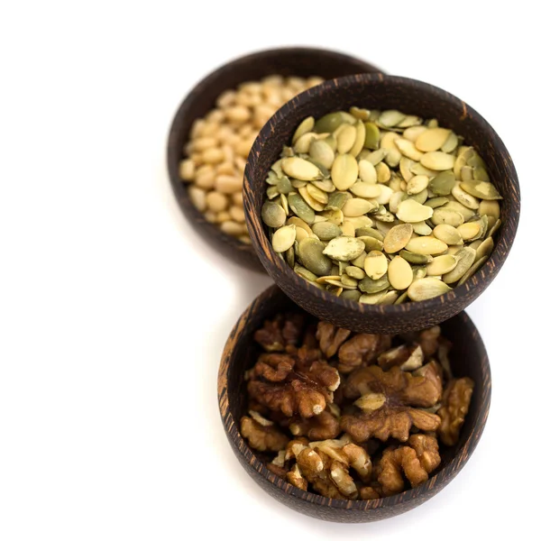 Nuts and pumpkin seeds in a wooden bowl on a white background — Stock Photo, Image