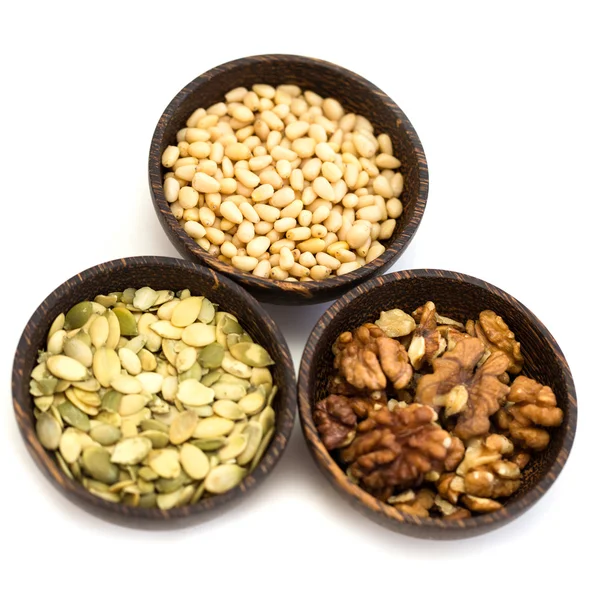 Nuts and pumpkin seeds in a wooden bowl on a white background — Stock Photo, Image