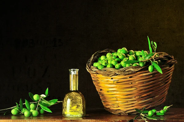 Green olives with bottle of olive oil — Stock Photo, Image