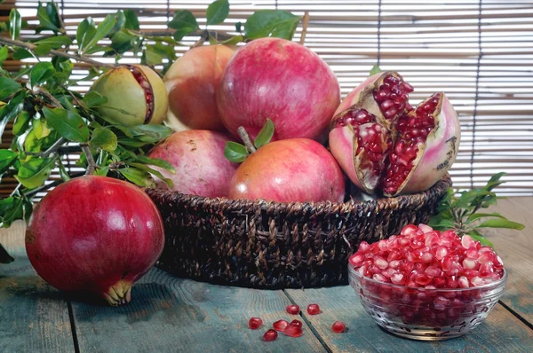 Pomegranates on an wooden board — Stock Photo, Image