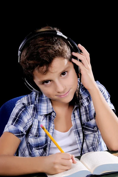 Little boy listening and writing — Stock Photo, Image