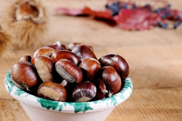 Chestnuts on wood — Stock Photo, Image