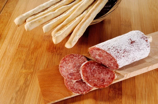 Bread sticks and salami — Stock Photo, Image