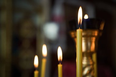 Burning church candles in the temple. The Christian religion, faith, wax, confession, blessing, prayer.