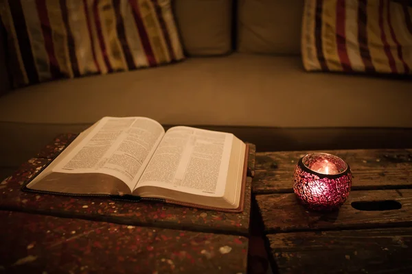 Reading Holy Bible on vintage table Stock Photo