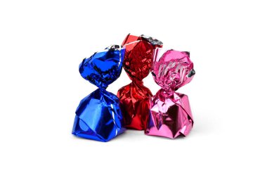 Chocolate candy with praline in color wrapper on white background.