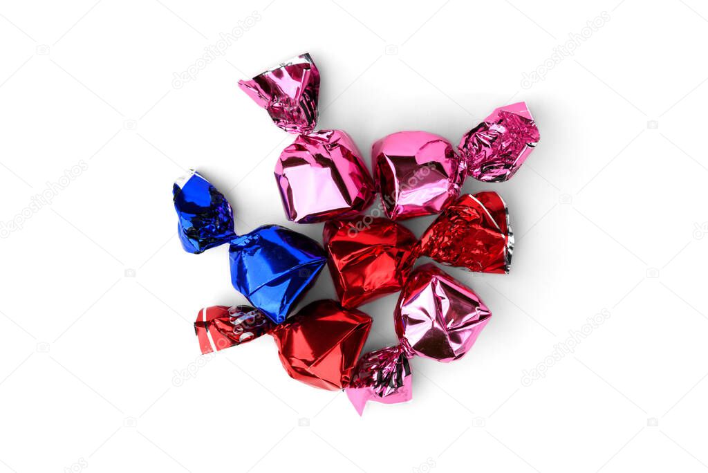 Chocolate candy with praline in color wrapper on white background.