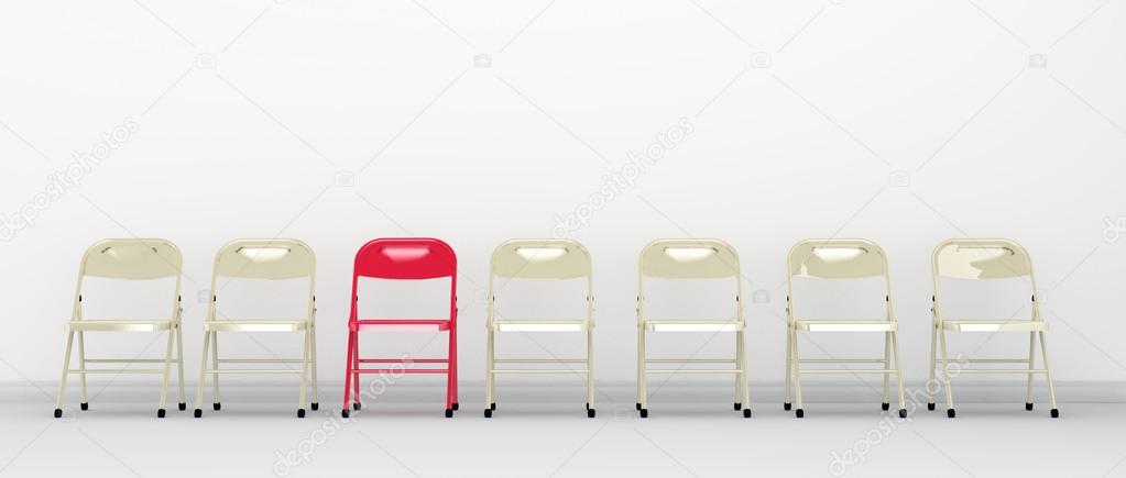 One red chair standing out in a row of chairs