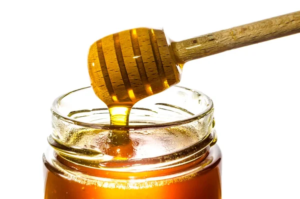 Getting Honey Jar Honey Spoon Isolated White Background Imágenes de stock libres de derechos