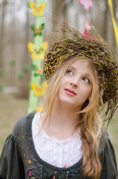 Close up portrait of a pretty pensive girl in the circlet of flo