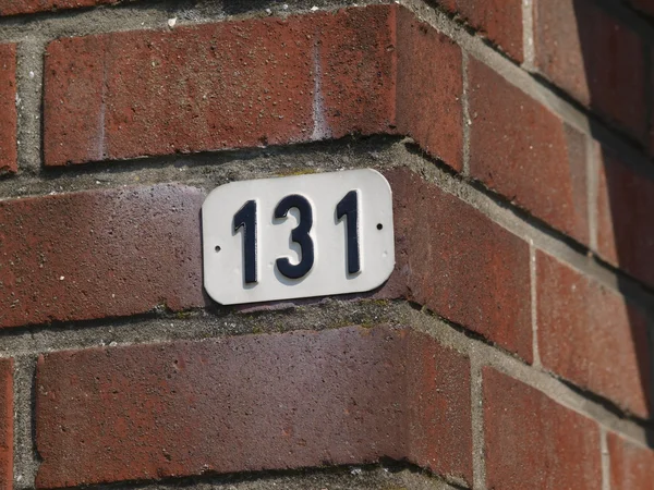 House number on brick wall