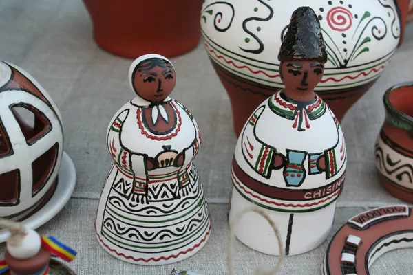 Clay figures of men and women in the Moldovan national costumes Stock Picture