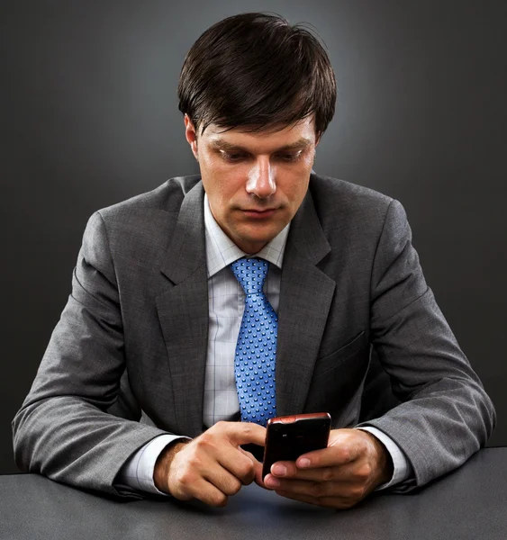 Young businessman sitting behind the desk — Stock Photo, Image