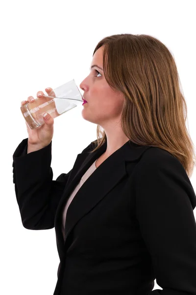 Young businesswoman drinking a glass of water — Stock Photo, Image