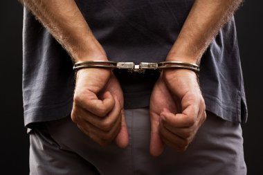 Close-up. Arrested man handcuffed clipart