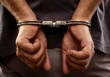 Arrested man handcuffed hands at the back clipart