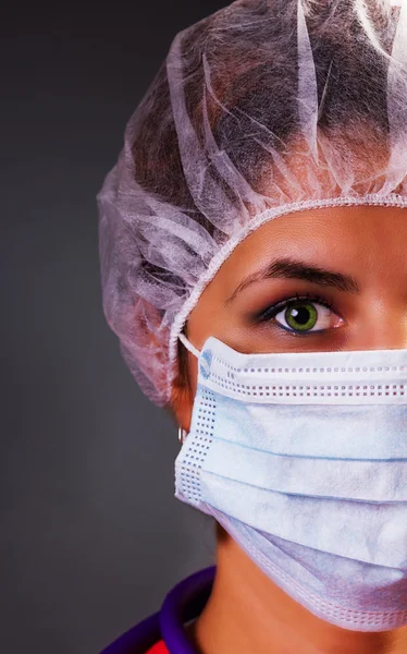 Крупный план портрета симпатичной медсестры или врача в хирургической маске — стоковое фото