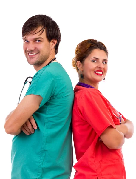 Happy team of two doctors standing back to back with arms folded — Stock Photo, Image