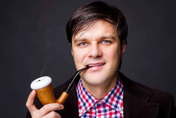Closeup of a young man smoking a pipe — Stock Photo, Image