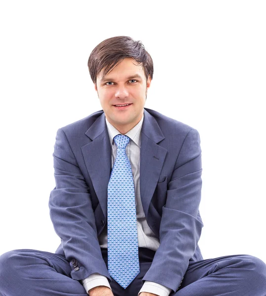 Closeup portrait of a young businessman sitting cross-legged — Stock Photo, Image