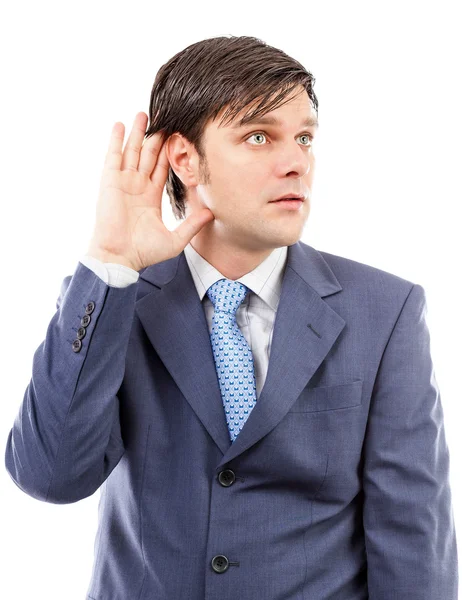 Young business man holding his hand to his ear — Stock Photo, Image