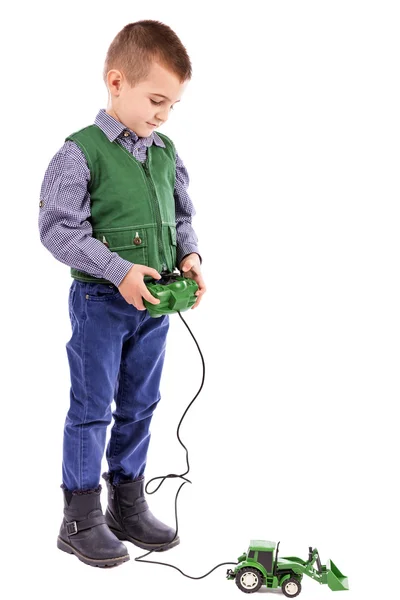 Portrait of a little boy playing with tractor toy — Stock Photo, Image