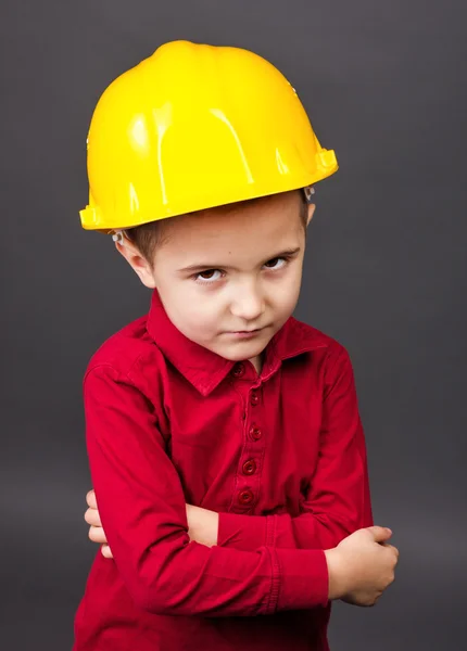 Portrait of a cute little boy with hardhat and arms folded — Stock Photo, Image