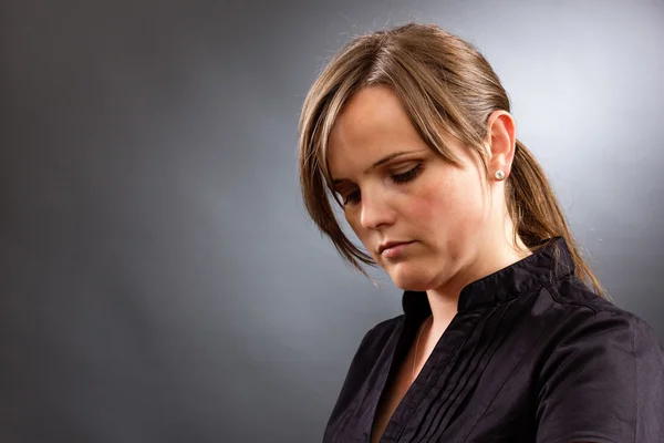 Portrait of a sad business woman looking down — Stock Photo, Image