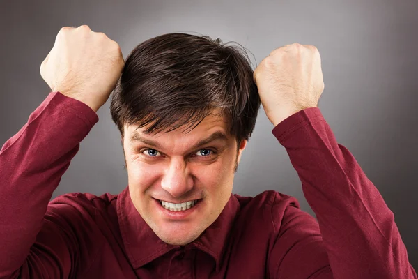 Portrait of a successful young man with hands lifted upwards — Stock Photo, Image