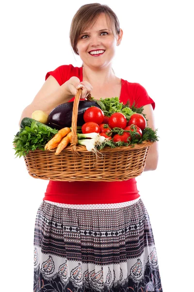 Happy young woman holding basket with fresh vegetables — Stock Photo, Image