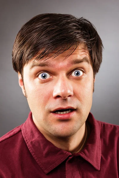 Young handsome man with astonished expression — Stock Photo, Image