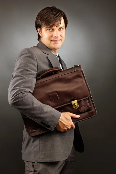 Young businessman holding his briefcase — Stock Photo, Image