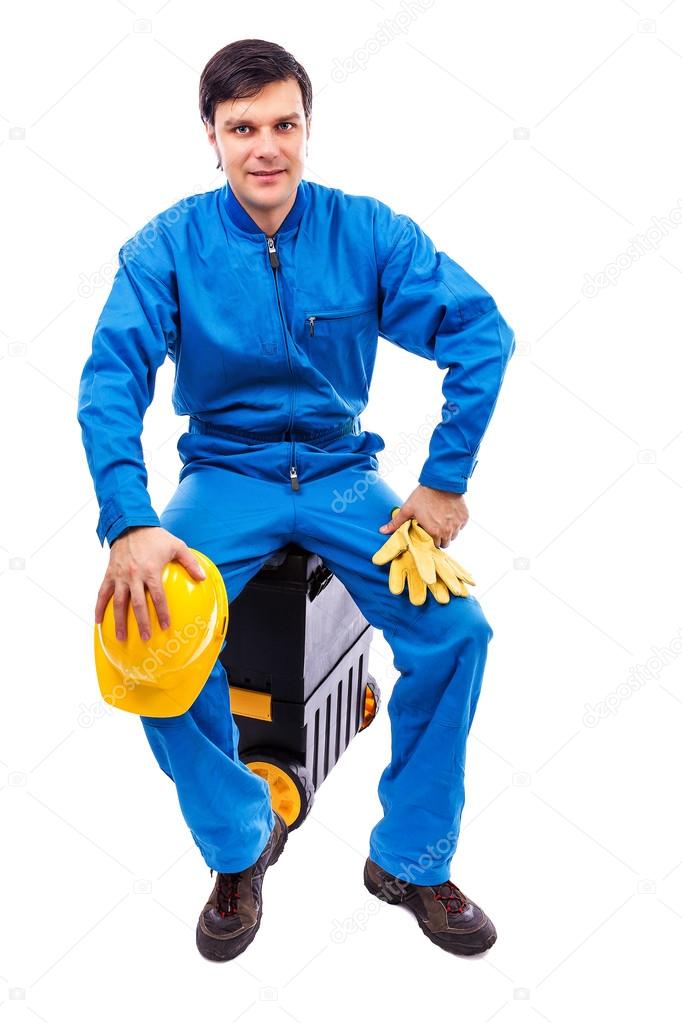 Young construction worker sitting on his toolbox