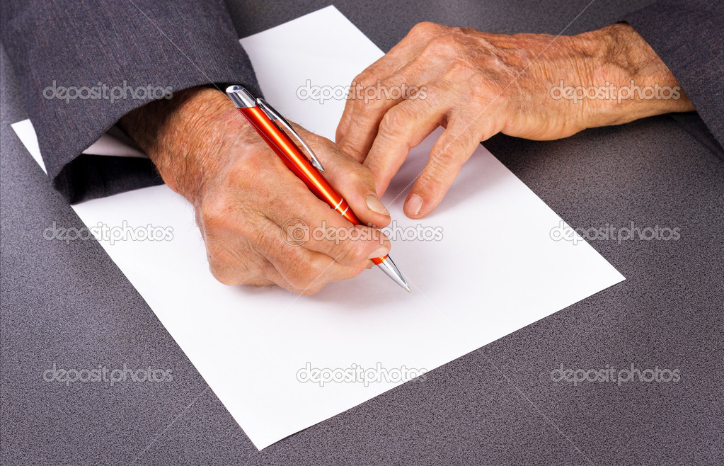 Old man hands writing with a pen