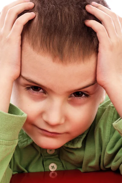 Closeup portrait of a little boy holding his both hands on head — Stock Photo, Image