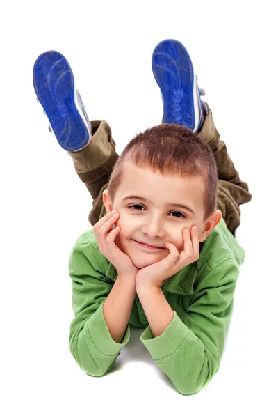 Adorable niño tendido en el suelo sosteniendo su cara con bot —  Fotos de Stock