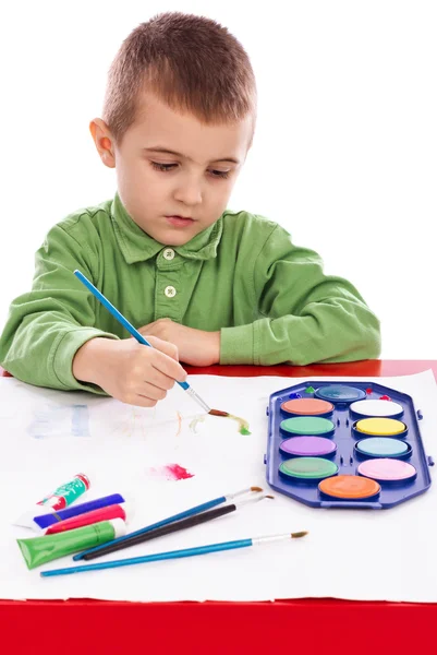 Cute little boy painting with brush Royalty Free Stock Images