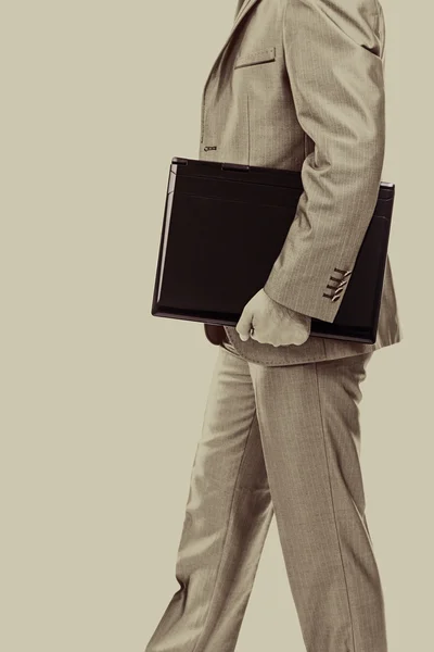 Businessman with laptop under his arm — Stock Photo, Image