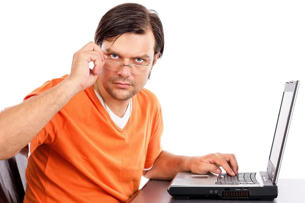Serious young man looking over his glasses — Stock Photo, Image