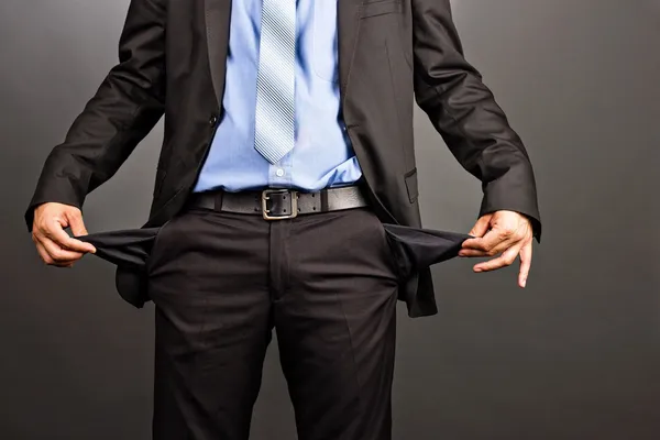 Business man showing his empty pockets — Stockfoto