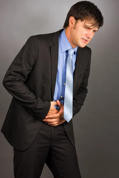 Young man with strong stomach pain — Stock Photo, Image