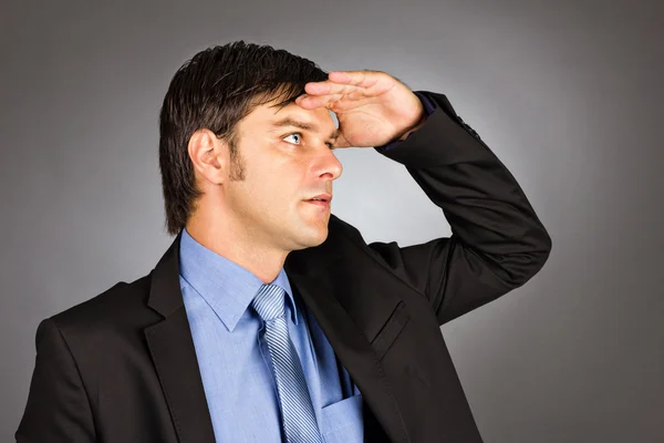 Young businessman holding his hand at forehead and looking forwa — Stock Photo, Image