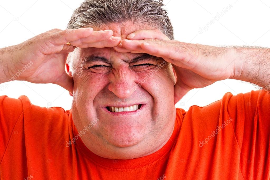 Portrait of an expressive man suffering from a severe headache