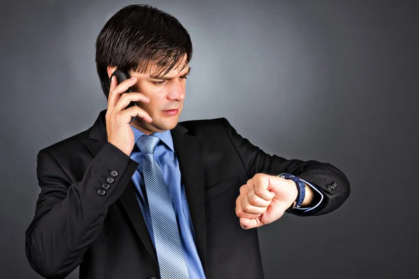 Young businessman looking at his watch — Stock Photo, Image