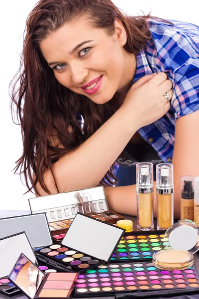 Young woman with a bunch of make up — Stock Photo, Image