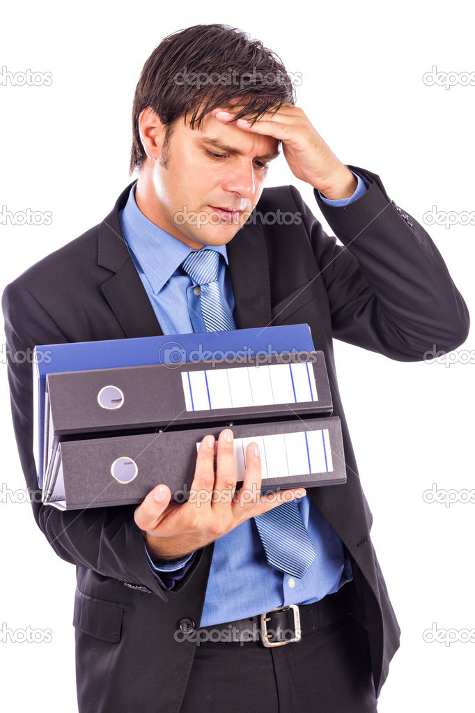 Overwhelmed young businessman holding many folders