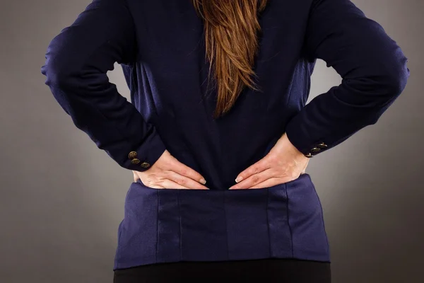 Closeup of businesswoman with back pain — Stock Photo, Image