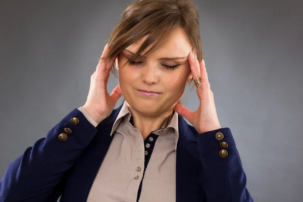 Closeup portrait of a young businesswoman with headache — Stock Photo, Image