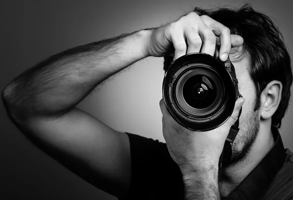 Young man with professional camera — Stock Photo, Image