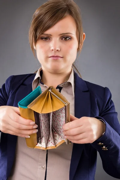 Portrait of a young businesswoman looking at her empty pocket — Stock Photo, Image